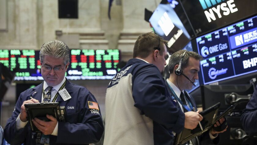 Traders work on the floor of the New York Stock Exchange on March 26.