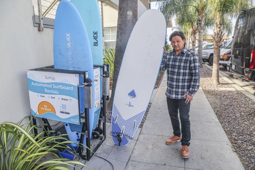 San Diego, CA - November 29: Albert Liu, vice president of strategy at SurfUp, demonstrates their on demand surfboard rental kiosk in Pacific Beach at the Diamond Head Inn on Tuesday, Nov. 29, 2022 in San Diego, CA. (Eduardo Contreras / The San Diego Union-Tribune)