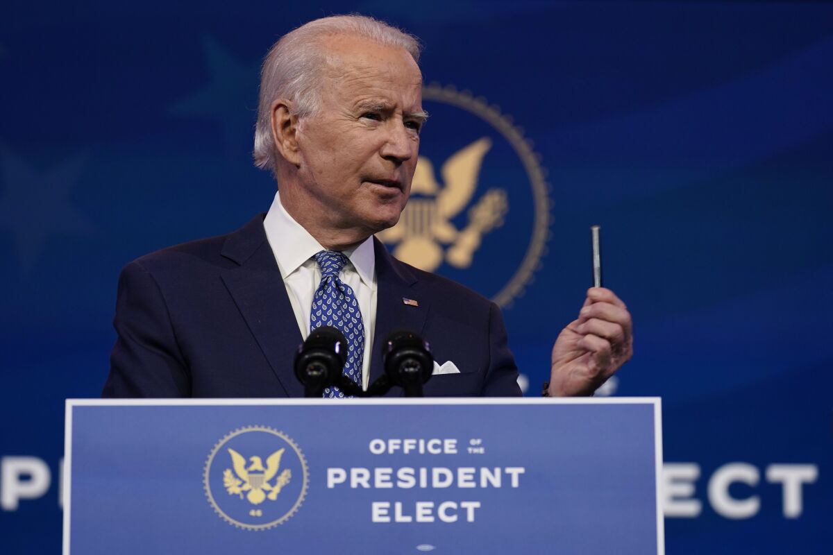 President-elect Joe Biden speaks into a microphone at a podium at the Queen Theater on Tuesday.