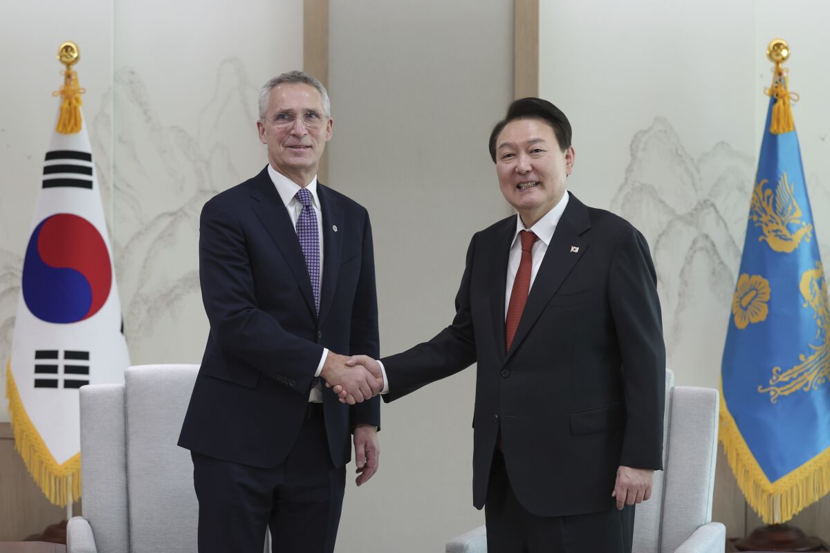 South Korean President Yoon Suk Yeol, right, shakes hands with NATO Secretary-General Jens Stoltenberg during a meeting at the presidential office in Seoul, South Korea, Monday, Jan. 30, 2023. (South Korea Presidential Office/Yonhap via AP)