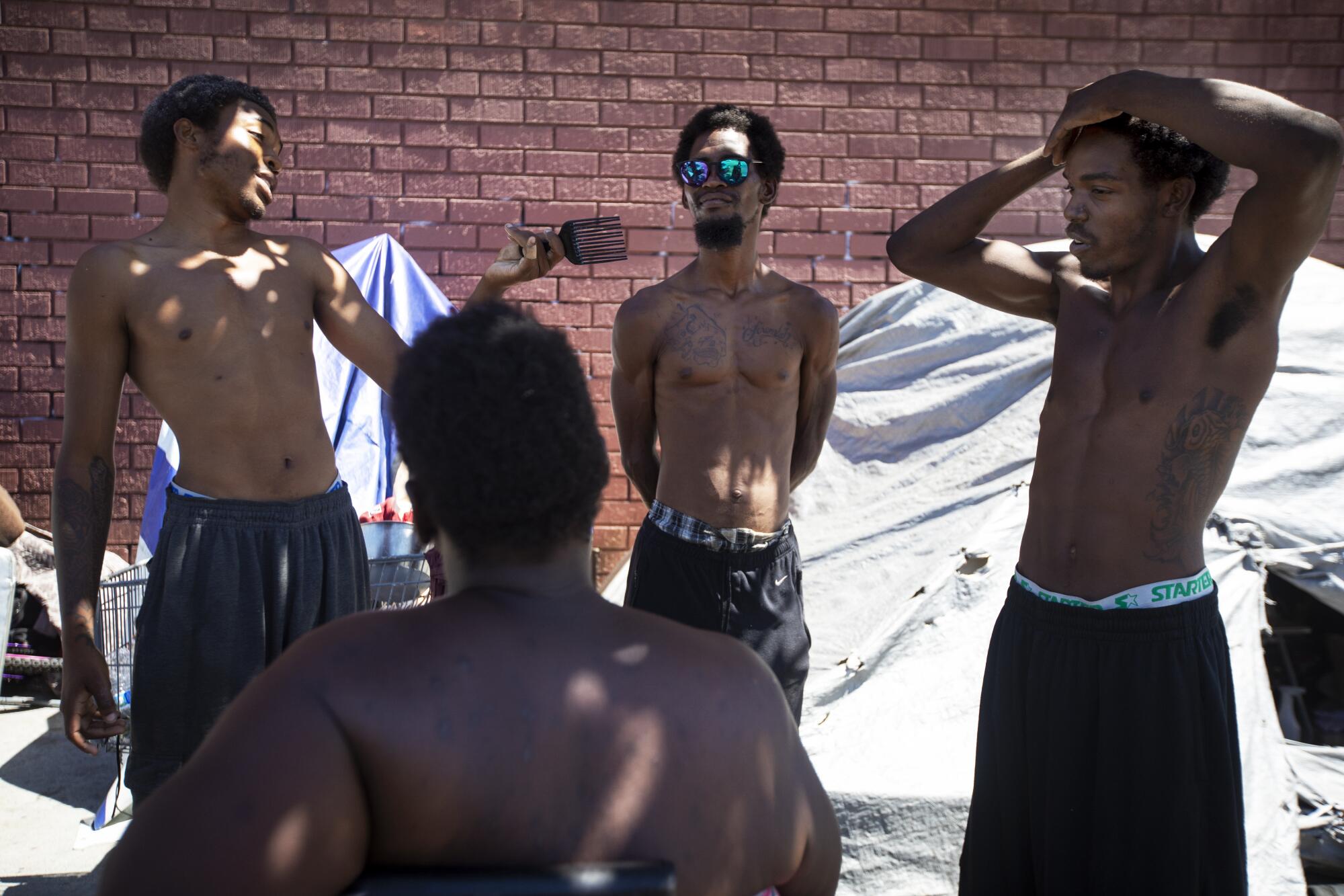 Leneace Pope, sitting, listens to Ameer Holloway, left, Jermaine Autry, Lloyd Cook.