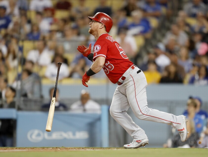 Angels right fielder Kole Calhoun tosses his bat after hitting a home run against the Dodgers in the fourth inning on Wednesday at Dodger Stadium.