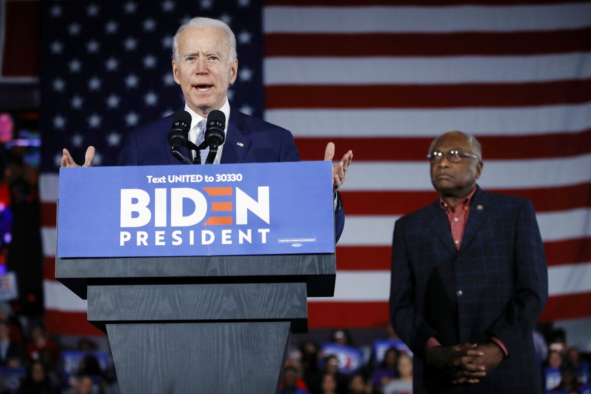 FILE - Democratic presidential candidate former Vice President Joe Biden speaks at a primary night election rally in Columbia, S.C., Feb. 29, 2020, after winning the South Carolina primary, as Rep. James Clyburn, D-S.C., watches. (AP Photo/Matt Rourke, File)