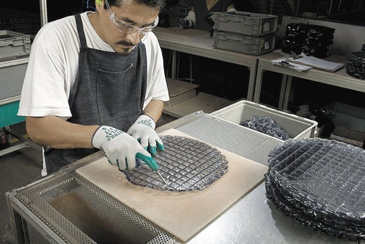 At Glasstile’s factory, tiles are hand-scored and broken apart to create loose mosaics. Nick Nacca