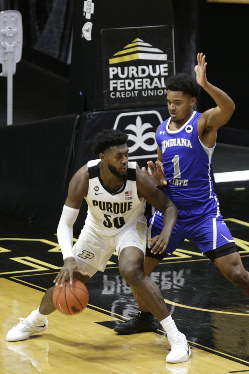 Purdue forward Trevion Williams (50) dribbles under the net against Indiana State's center Tre Williams (1) during the second half of an NCAA men's basketball game, Saturday, Dec. 12, 2020, in West Lafayette, Ind. (Nikos Frazier/Journal & Courier via AP)