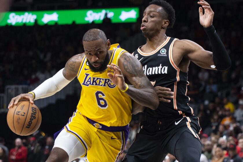 Los Angeles Lakers forward LeBron James drives against Atlanta Hawks forward Onyeka Okongwu.