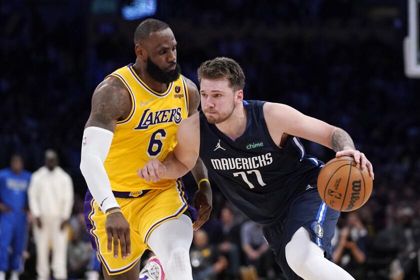 Dallas Mavericks guard Luka Doncic, right, drives past Los Angeles Lakers forward LeBron James during the second half of an NBA basketball game Tuesday, March 1, 2022, in Los Angeles. (AP Photo/Mark J. Terrill)