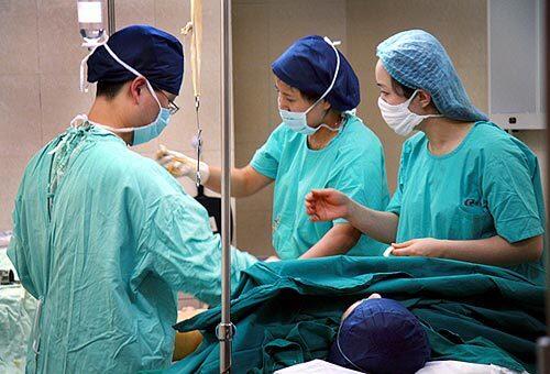 A young female patient undergoes liposuction at Shanghai Time Plastic Surgery Hospital in downtown Shanghai. Some Chinese have sought to improve their appearance in hopes of boosting their job prospects amid an economic downturn.