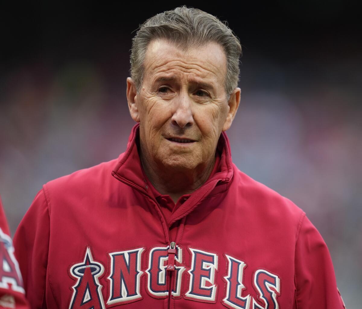 Arte Moreno, owner of the Los Angeles Angels, stands on the field before a baseball game.