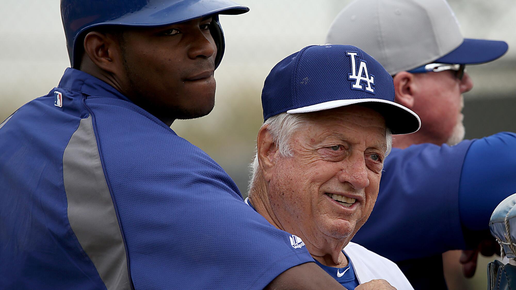 Dodgers outfielder Yasiel Puig hugs Tommy Lasorda during spring training in February 2014.