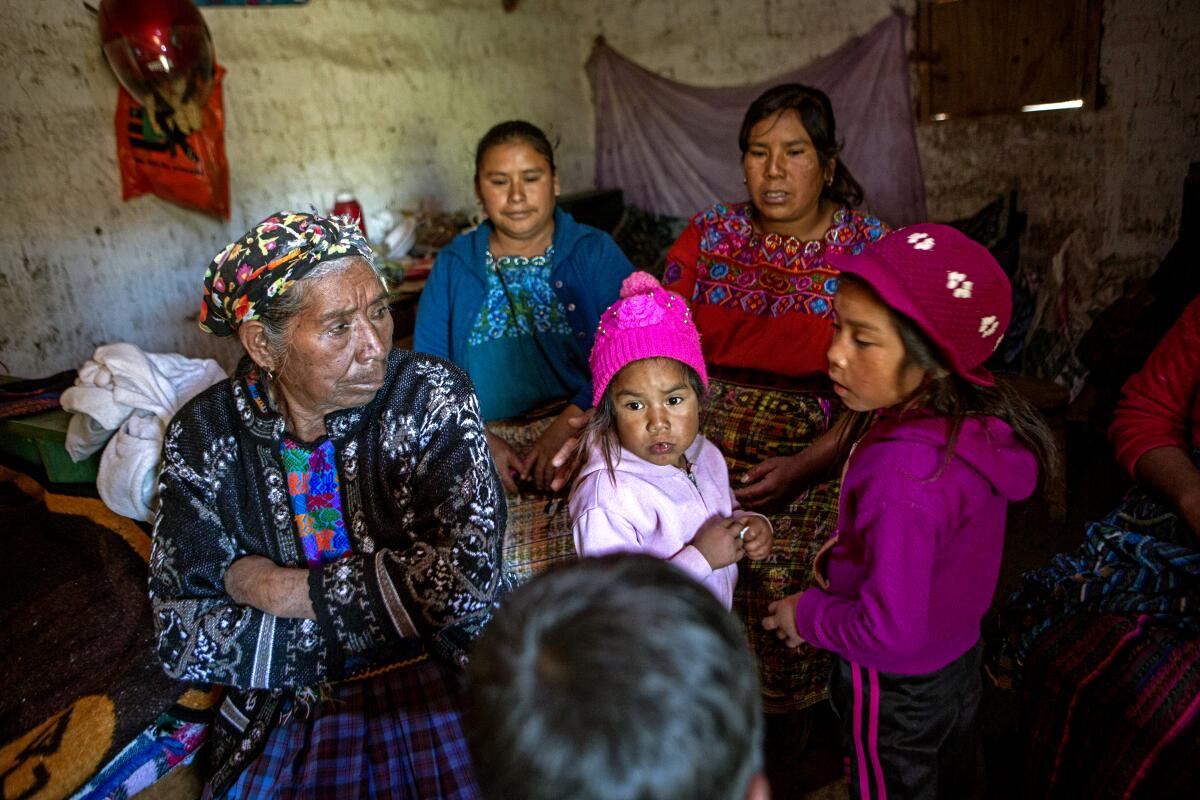 Family and neighbors of migrant Rivaldo Jimenez gather at his home in Comitancillo, Guatemala