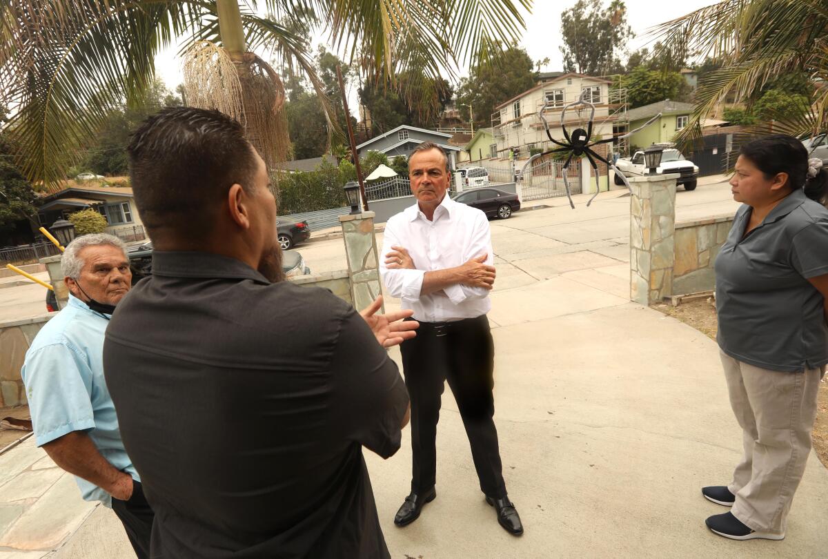 Mayoral candidate Rick Caruso listens to residents of Highland Park.