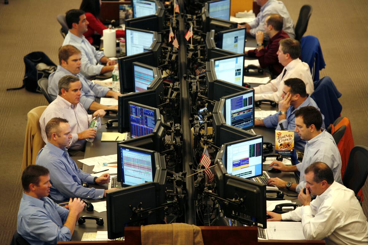 Traders work at Knight Capital Group in Jersey City, N.J.