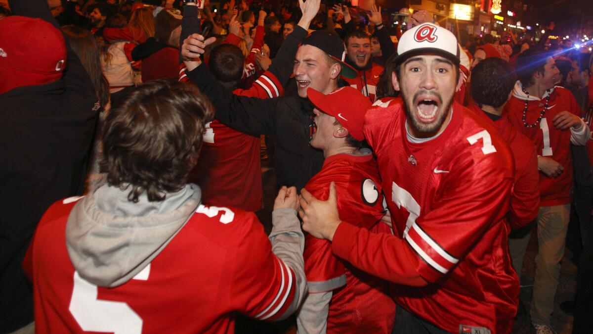 Ohio State fans celebrate on High Street in Columbus, Ohio, early Tuesday morning after the Buckeyes' national championship win over Oregon.