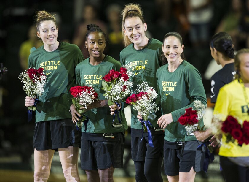 Seattle Storm's Katie Lou Samuelson, Jewell Loyd, Breanna Stewart and Sue Bird receive flowers to congratulate them on making the 2021 Team USA Women's Basketball team on Sunday, July 11, 2021 in Everett, Wash. (Olivia Vanni/The Herald via AP)