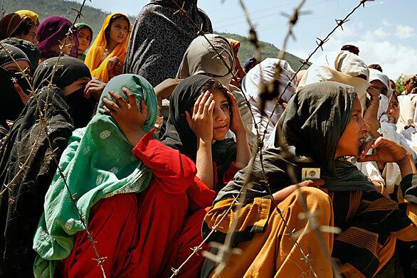 Women wait for government food aid in Ambela, one of the main towns of Buner district, where a Taliban incursion sparked the Pakistani offensive in late April. More than 2 million residents fled the region as fighting escalated; the government aid is meant to encourage residents to return. Full coverage of the conflict in northwest Pakistan.