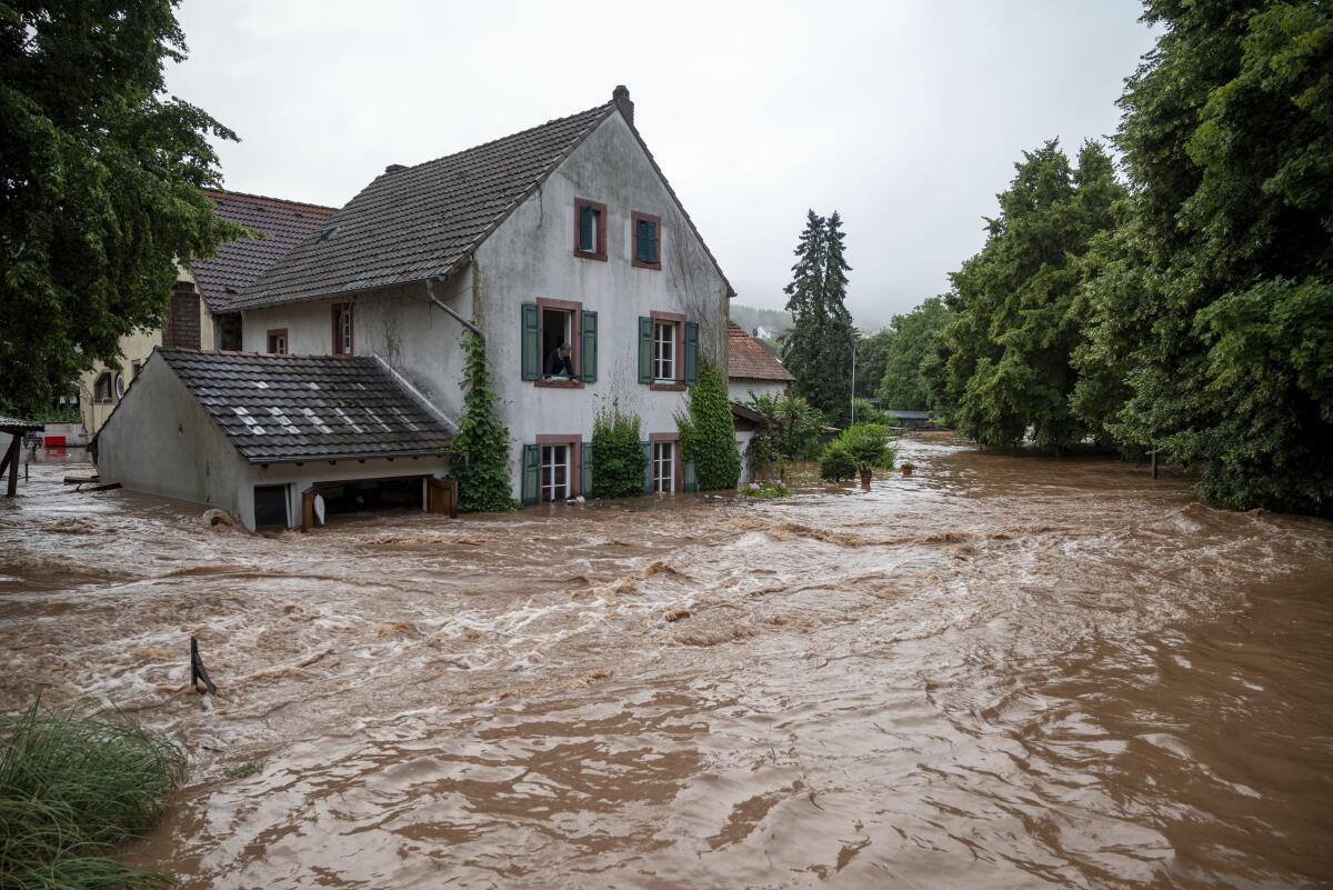 Houses are partially submerged on overflowed river banks