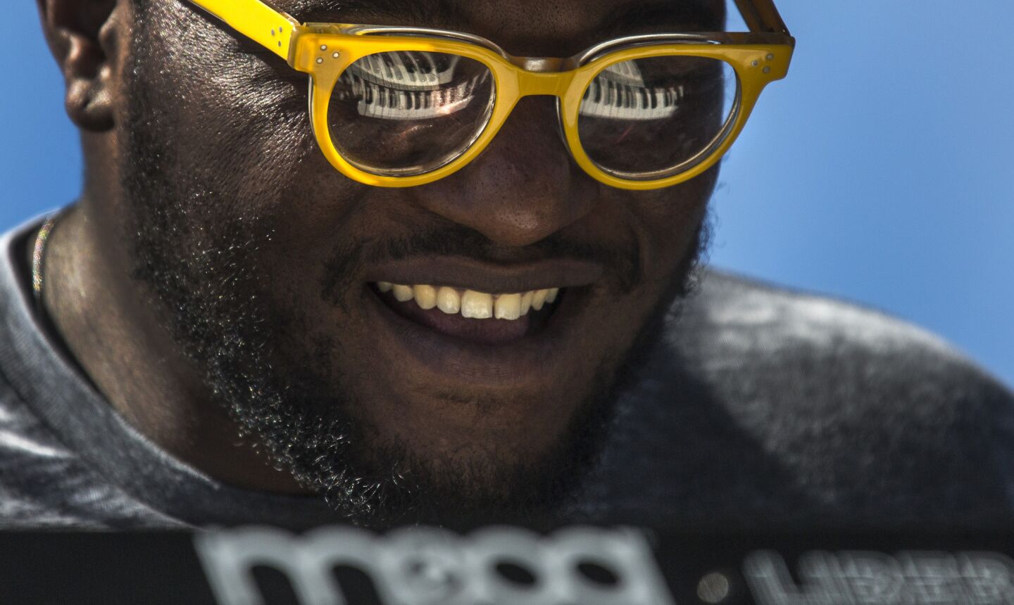 Brandon Coleman's synthesizer keys are reflected in his sunglasses as he performs with Kamasi Washington at the Outdoor Theatre at Coachella.