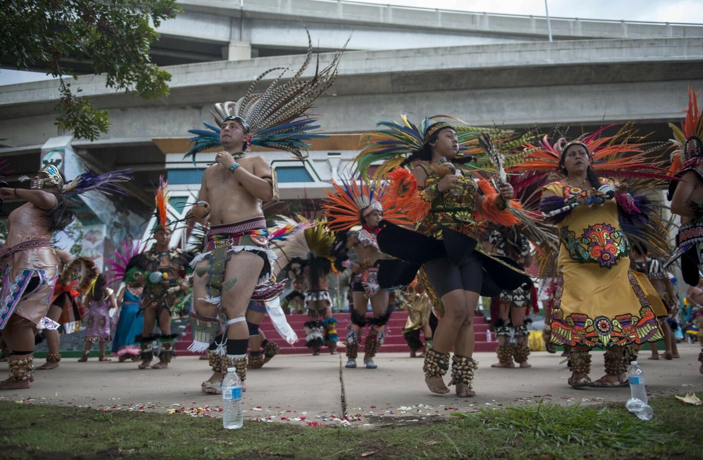People dance during a traditional Aztec dance ceremony to commemorate the anniversary of Danza Mexicayotl at Chicano Park.