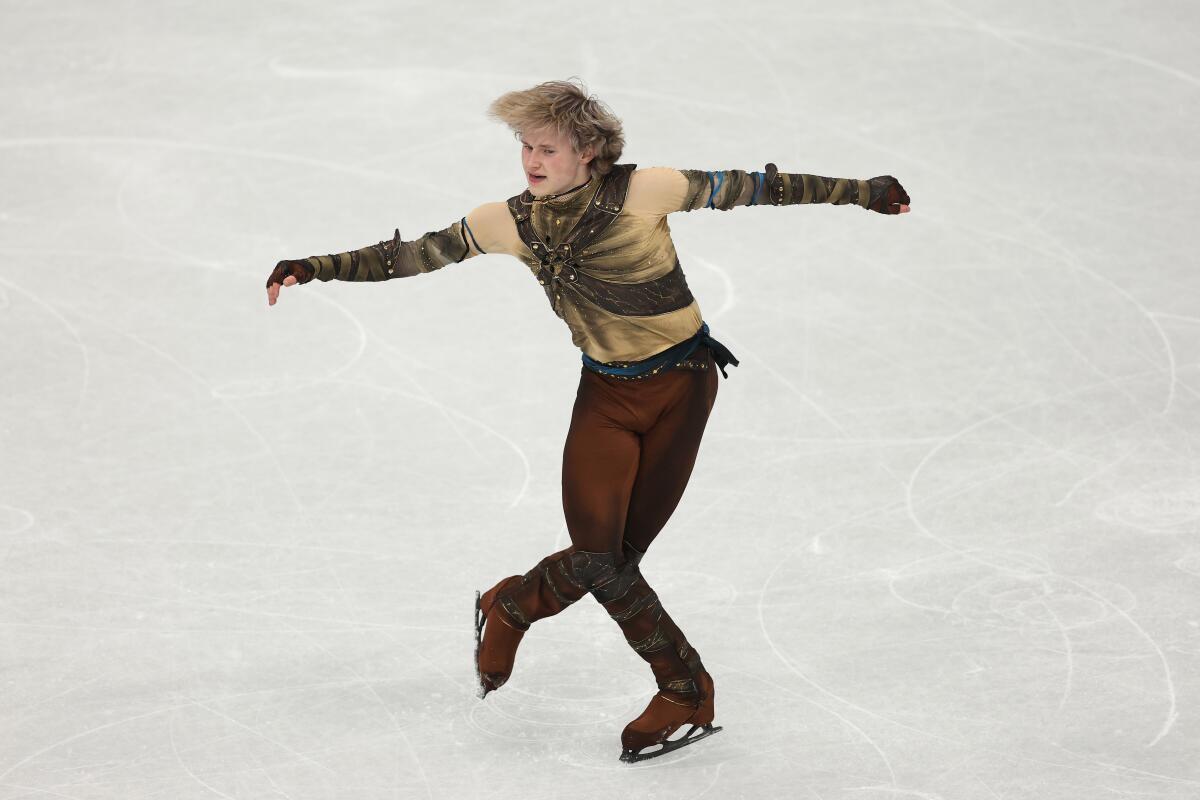 Ilia Malinin conserves energy, but U.S. still leads Olympic team skate - Los Angeles Times