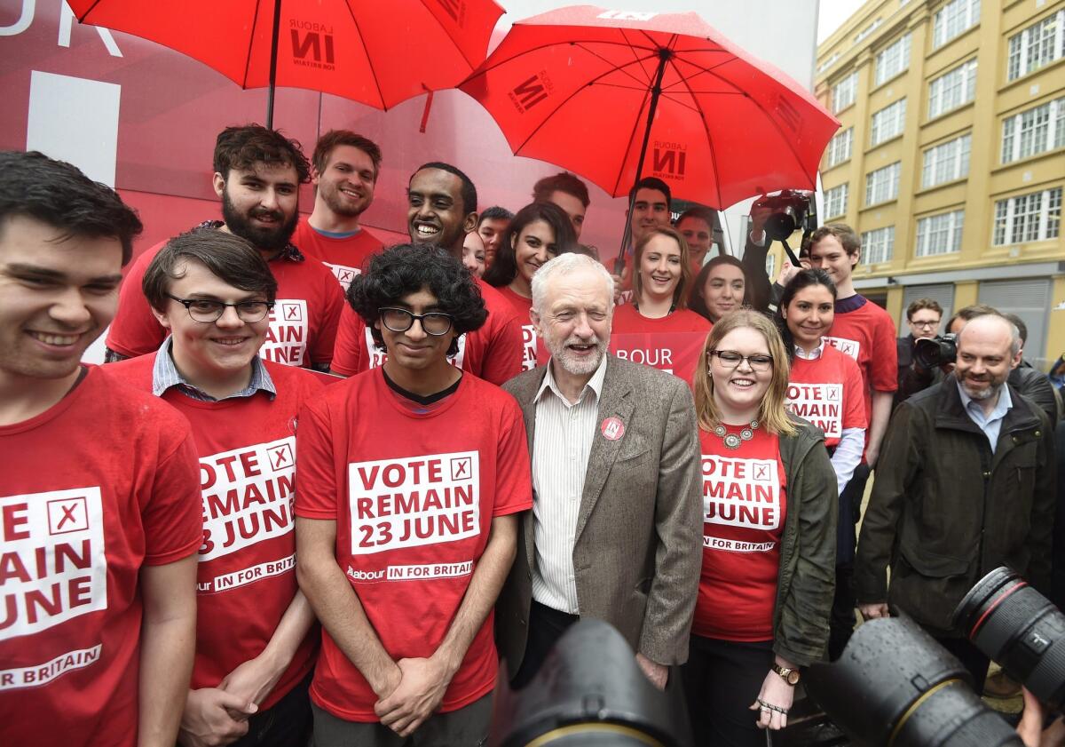 Labor Party leader Jeremy Corbyn stands with vote "remain" supporters in London on May 10, 2016, during the unveiling of a campaign bus for the upcoming referendum on the European Union.