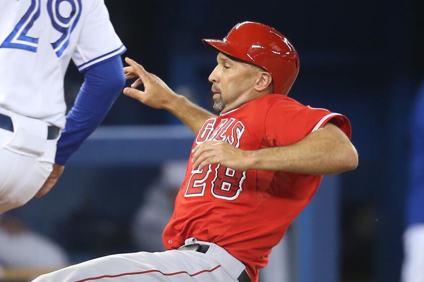 Angels designated hitter Raul Ibanez slides into home plate during Friday's win over the Toronto Blue Jays.