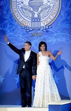 US President Barack Obama with his wife US First Lady Michelle Obama wave on their arrival to attend the Mid-West Presidential Inaugural Ball in Washington D.C.
