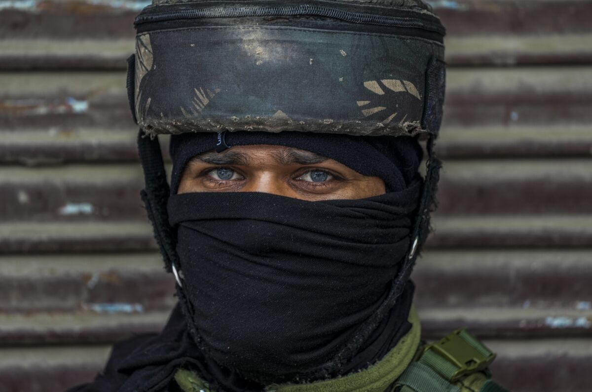 An Indian soldier guards at the site of a grenade explosion in Srinagar, Indian controlled Kashmir, Sunday, March 6, 2022. At least one civilian was killed and nearly two dozen were injured when a grenade was thrown in the middle of the crowd at a busy market in Srinagar. (AP Photo/Mukhtar Khan)