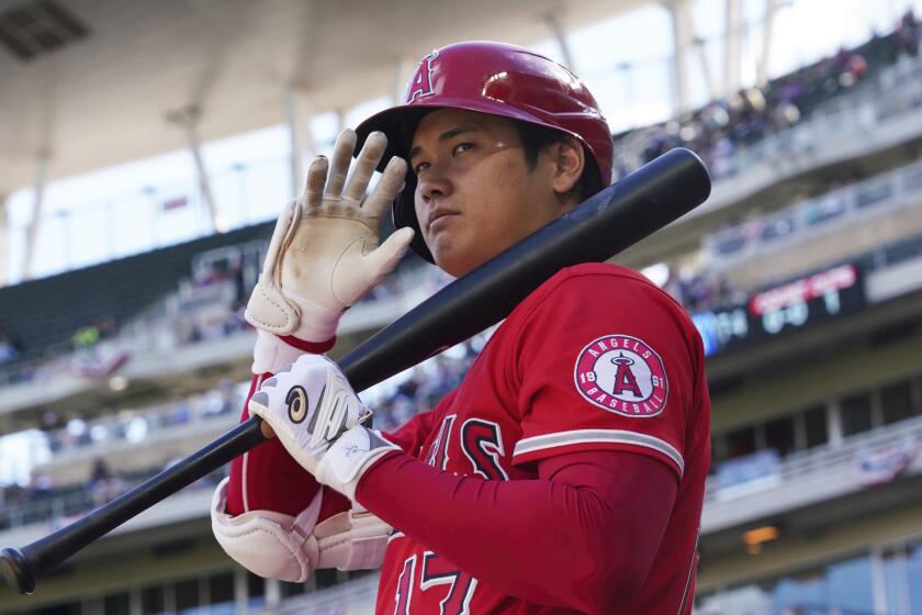 Los Angeles Angels' pitcher Shohei Ohtani (17) waves to fans as he waits on deck.