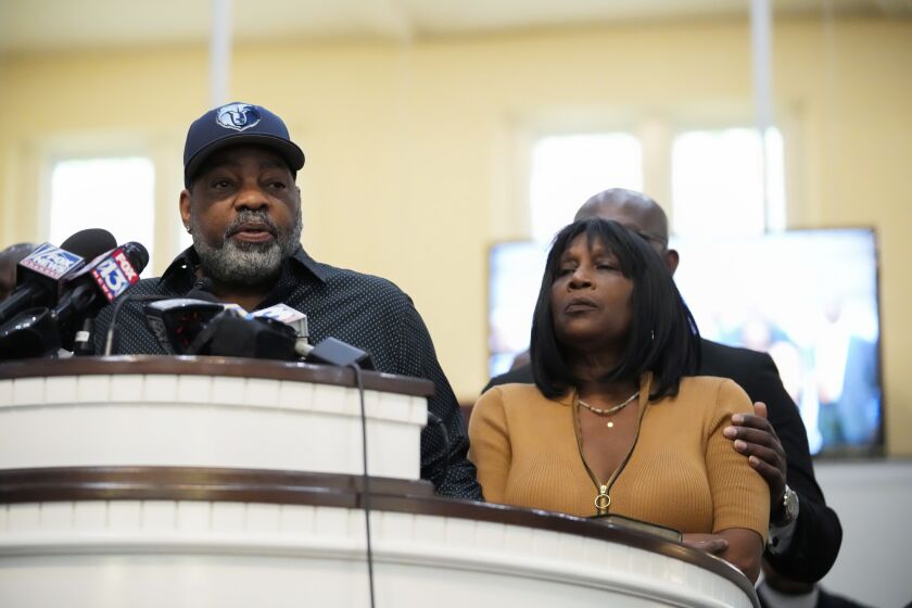 Rodney Wells, stepfather of Tyre Nichols, who died after being beaten by Memphis police officers, speaks at a news conference with civil rights Attorney Ben Crump, seen comforting Tyre's mother RowVaughn Wells, in Memphis, Tenn., Friday, Jan. 27, 2023. (AP Photo/Gerald Herbert)