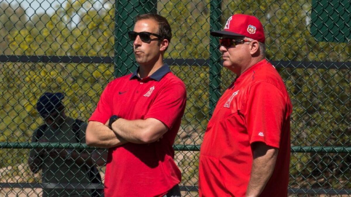 Angels General Manager Billy Eppler and Manager Mike Scioscia watch batting practice during spring training in Tempe, Ariz., on Feb. 26, 2016.