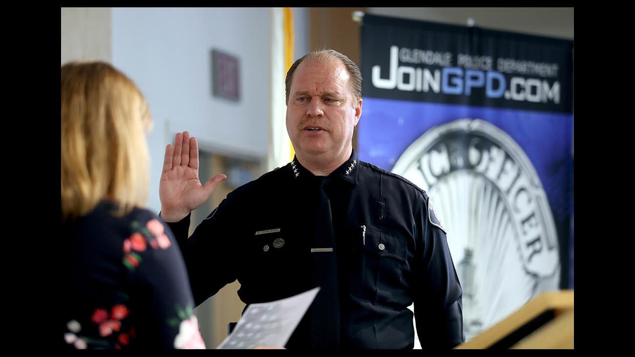 Glendale city manager Yasmin Beers, left, swears in new police chief Carl Povilaitis, during ceremony at police headquarters in Glendale, on Thursday, May 31, 2018.