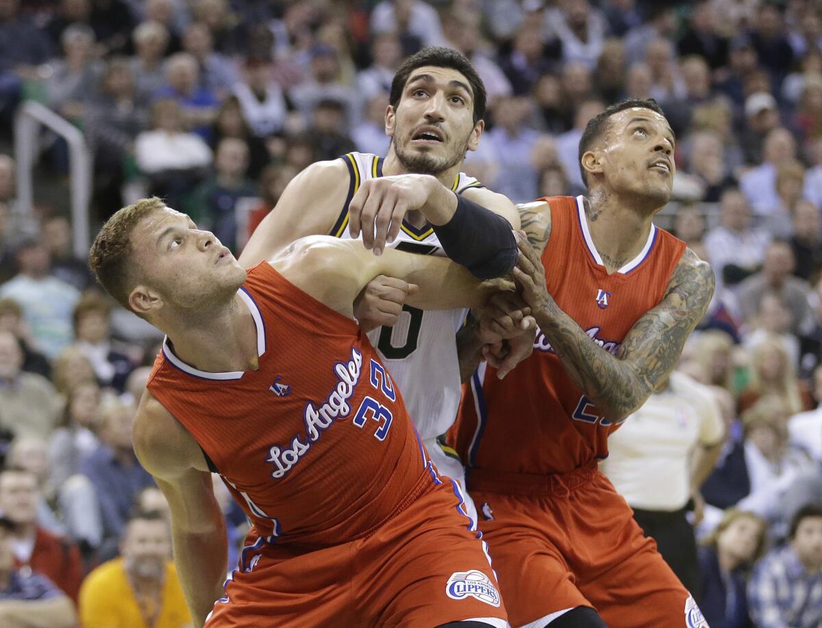 Blake Griffin and Matt Barnes box out Utah's Enes Kanter during the second half of the Clippers' 94-89 win over the Jazz.