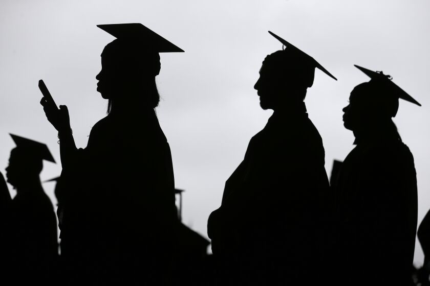 FILE- In this May 17, 2018, file photo, new graduates line up before the start of the Bergen Community College commencement at MetLife Stadium in East Rutherford, N.J. In high school, students hear that they should earn a college degree to have a well-paying, successful career. But student debt isn’t good when your degree doesn’t lead to a job that earns enough to repay it. (AP Photo/Seth Wenig, File)
