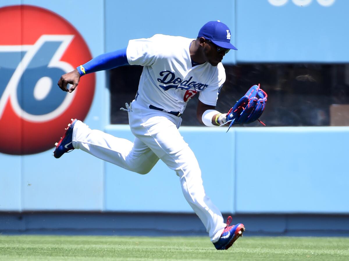 Dodgers outfielder Yasiel Puig makes a running catch to get San Diego first baseman Yonder Alonso out during the first inning.