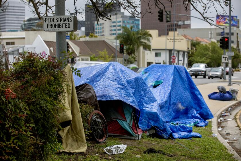 LOS ANGELES, CA-APRIL 14, 2023: A homeless encampment in located on the median along San Vicente Blvd. just south of the Beverly Center in the city of Los Angeles. (Mel Melcon / Los Angeles Times)
