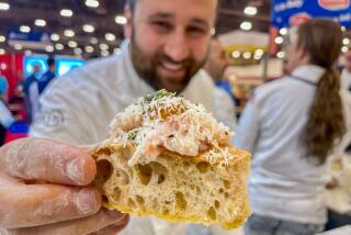 Chef Daniele Uditi holds a piece of focaccia nel ruoto at the 40th annual Pizza Expo in Las Vegas.