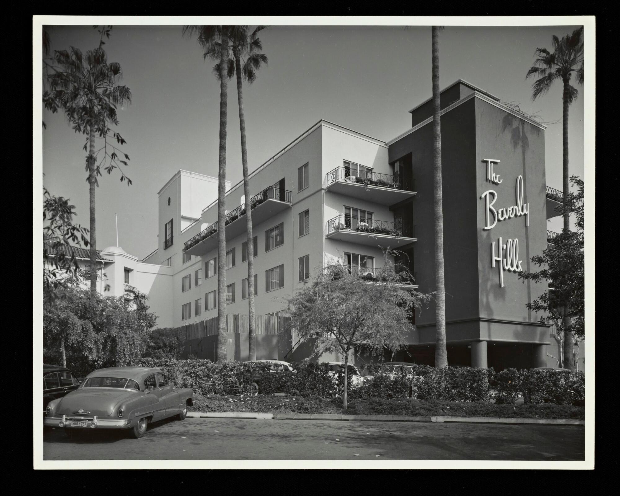 A black-and-white photo shows the Modern wing of the Beverly Hills Hotel with the hotel's name on the façade.