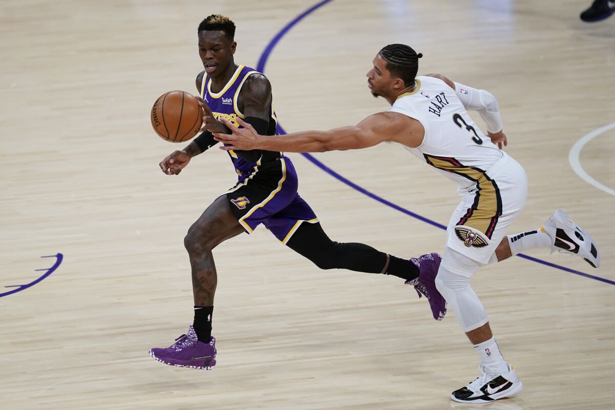 Pelicans guard Josh Hart, right, tries to take the ball from Lakers guard Dennis Schroder.