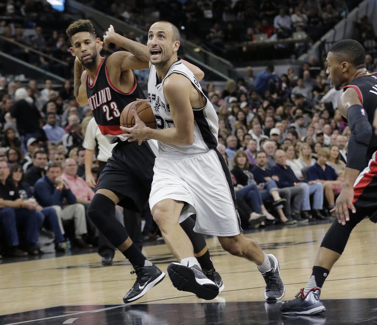 Spurs guard Manu Ginobili drives past Trail Blazers forward Allen Crabbe (23) to score during the second half.