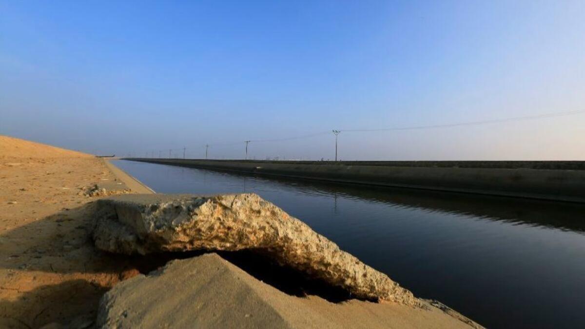 Buckled concrete sits along the Delta Mendota Canal on Jan. 13, 2015, near Los Banos. The ground is sinking due to overpumping groundwater in the San Joaquin Valley.