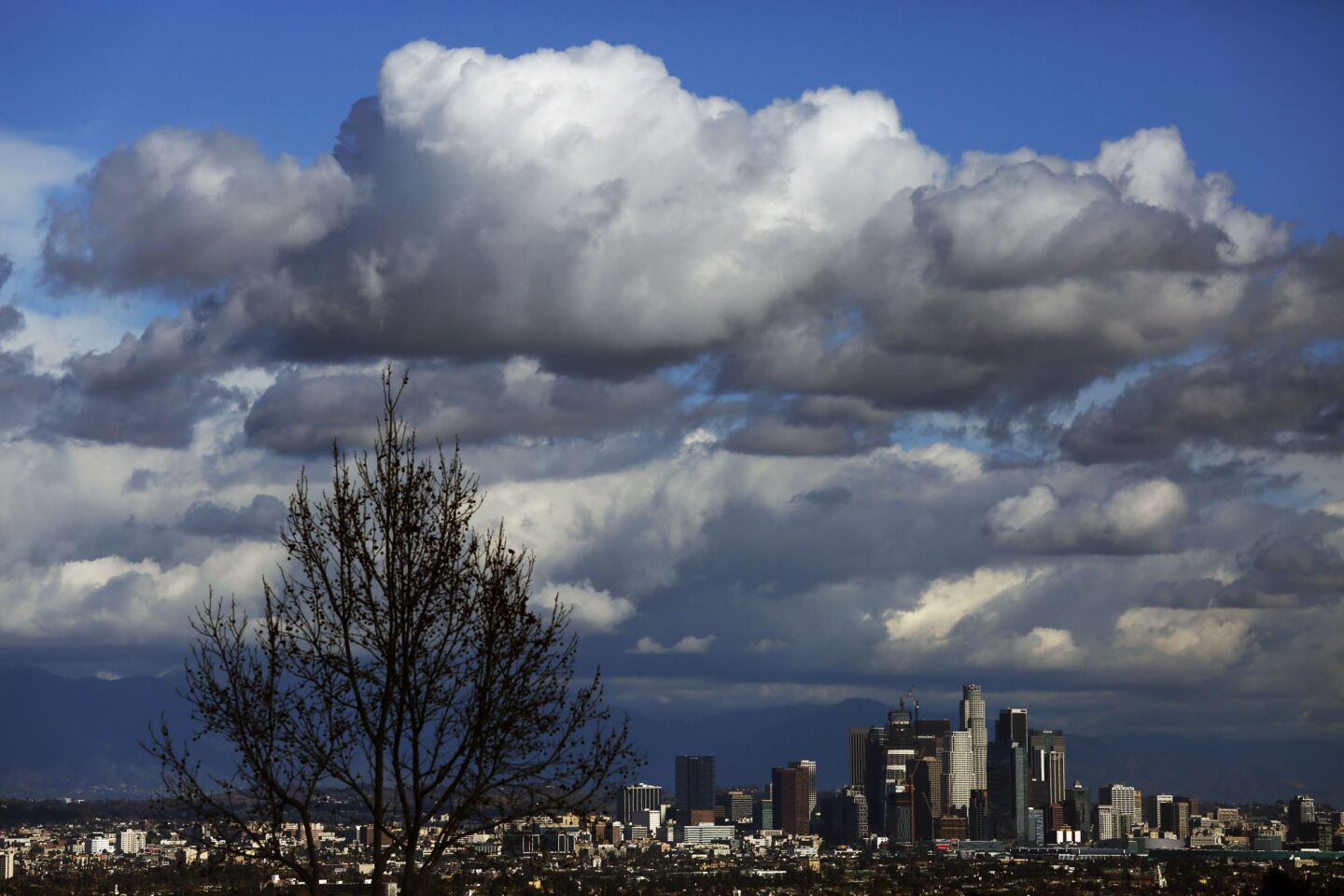 A passing storm, as seen from the Kenneth Hahn State Recreation Area, makes its way over Los Angeles on Thursday.