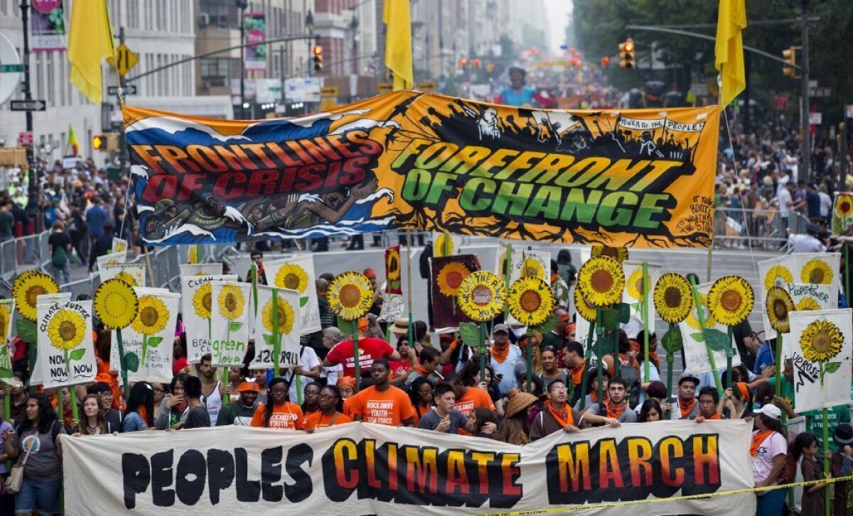 People gather Sunday near New York's Columbus Circle before the start of a march against climate change.