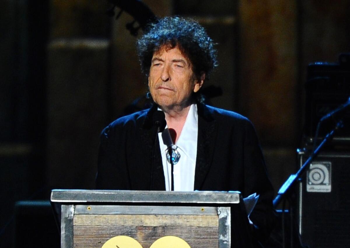 FILE - In this Feb. 6, 2015, file photo, Bob Dylan accepts the 2015 MusiCares Person of the Year award at the 2015 MusiCares Person of the Year show in Los Angeles. Dylan, who has a reputation as a relentless road warrior, has returned to the stage for the first time since things shut down because of the pandemic...at least on film. Dylan gave a 13-song performance Sunday, July 18, 2021, for fans who paid $25 to see him through the live-streaming platform Veeps. (Photo by Vince Bucci/Invision/AP, File)