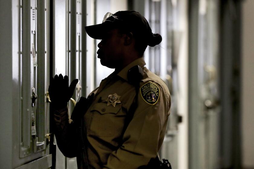 Represa CA - April 13: A California Department of Corrections and Rehabilitation officer checks on inmates at the Short-Term Restricted Housing Unit of California State Prison, Sacramento. The unit is for prisoners in segregated or solitary confinement. The California legisature is considering another bill (AB 280) to restrict solitary confinement after a similar proposal died last year. (Luis Sinco / Los Angeles Times)