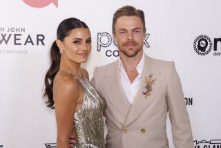 Hayley Scott, left, and Derek Hough arrive at the Elton John AIDS Foundation Academy Awards Viewing Party 
