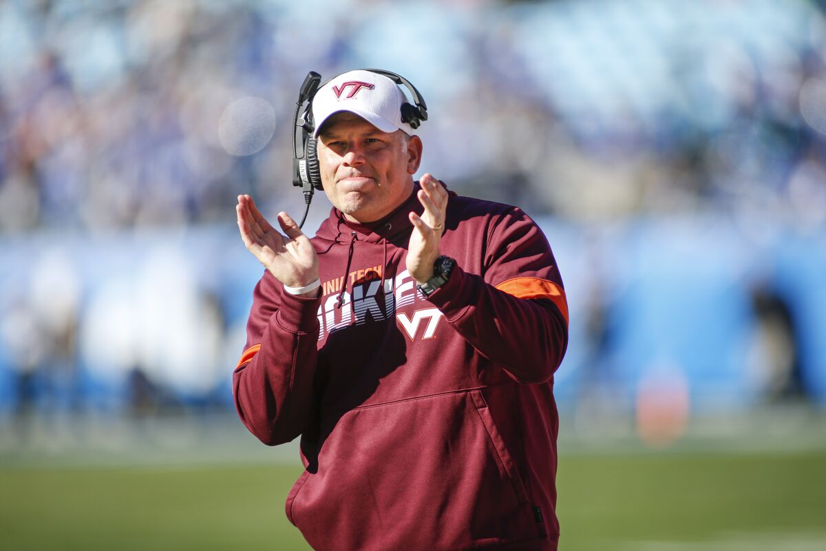 Virginia Tech coach Justin Fuente claps on the sideline.