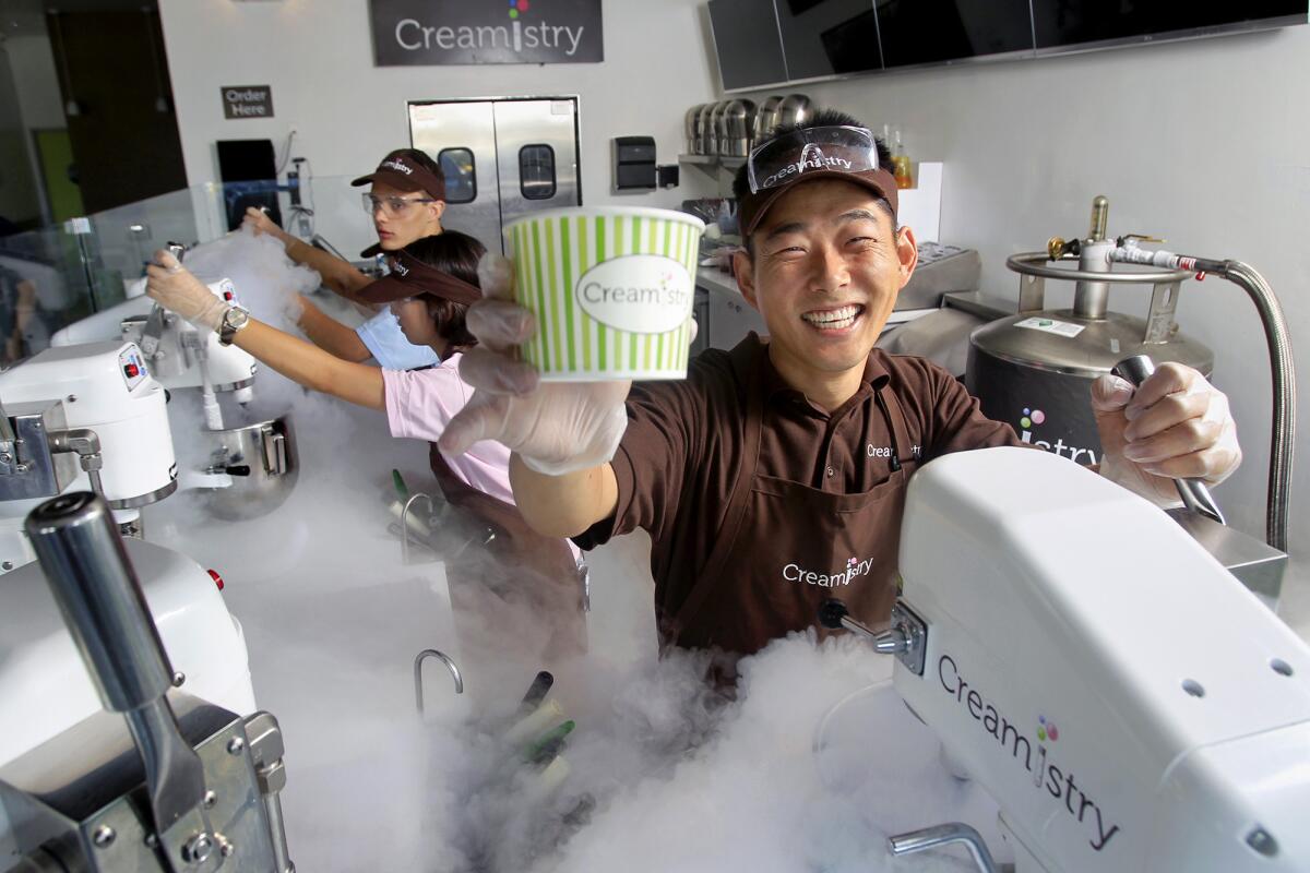 Owner Jay Yim, 33, right, of Yorba Linda poses for a portrait at Creamistry in Irvine on Thursday. Creamistry is the first liquid nitrogen ice cream shop in Orange County.