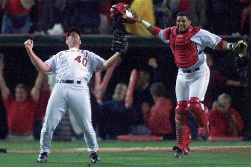 Angel relief pitcher Troy Percival and catcher Bengie Molina celebrate the team's Game 7 World Series win over the San Francisco Giants in 2002.