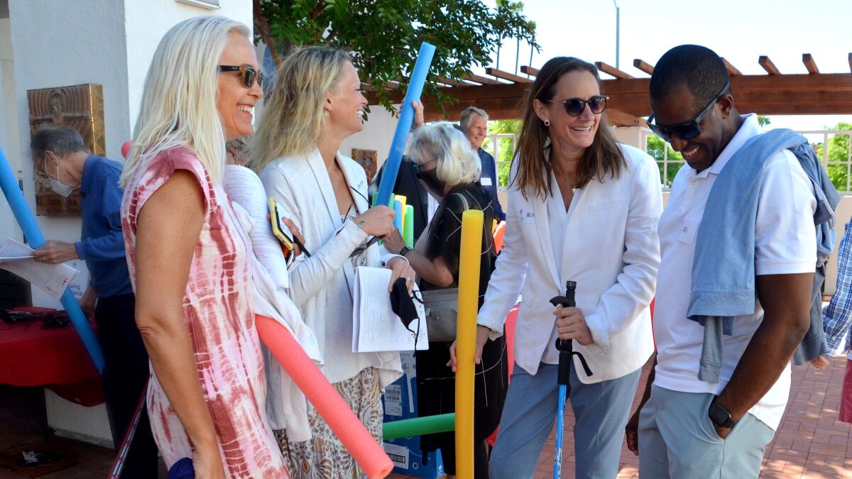 Bishop's Warden Meagan Cooper, center right, celebrates PRIDE month.
